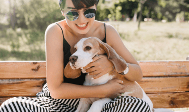 Young girl hugging Beagle dog
