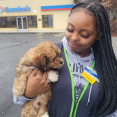 Woman holding her newly delivered puppy