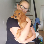 Mawoo customer holding her puppy in her house